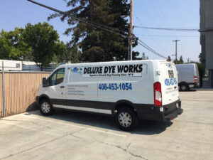 Numerous rolled oriental and area rugs stored in the processing facility at Deluxe Dye Works in San Jose, CA.