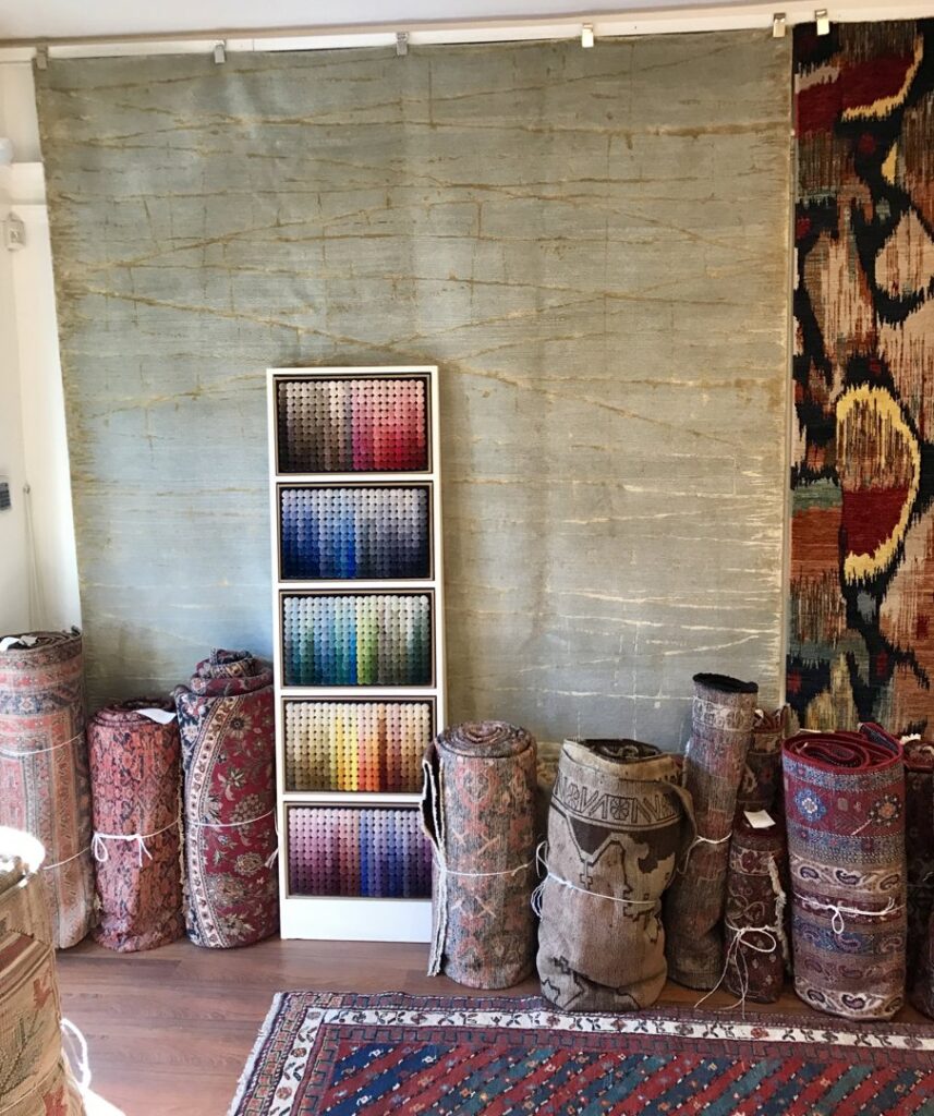 Rolled oriental rugs and a display of color swatches for custom orders at Robert Fritz Oriental Rugs, Inc. in Raleigh, NC