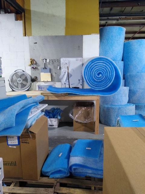 Rolls and stacks of blue HVAC filter media in the inventory of Murray Filter Sales and Service, Inc. in Nashville, TN
