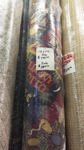 Several rolls of carpet with price tags displayed for sale at Nelson Floor Covering in Westland, MI