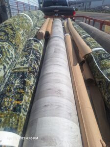 Various rolls of carpet and vinyl flooring loaded on a truck by AFAB Carpets in Tampa, FL.
