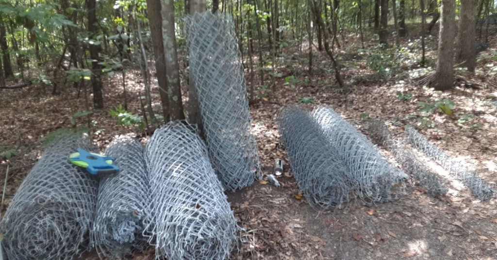 Rolls of chain-link fencing material on a job site for Jen and Vince and the PreOwned Fence in Augusta, GA.