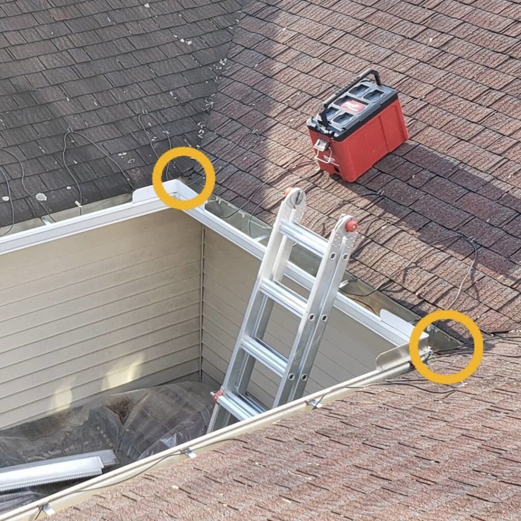 A roof with a ladder and pest or wildlife control wires installed along the gutter by Serene Property Services LLC in Albany, NY