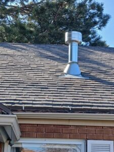 A newly installed metal vent pipe on a residential roof by Utah Mechanical Heating and Air Conditioning in South Ogden, UT.