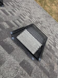 A protective metal mesh cover installed over a roof vent for wildlife exclusion by Elite Wildlife Removal and Prevention in Nashville, TN.