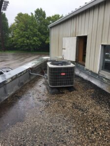 An outdoor Bryant AC condenser unit installed on a rooftop by Wise Heating & Air Conditioning, LLC in Louisville, KY.