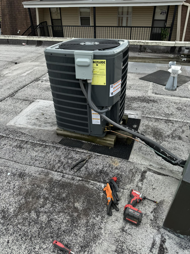 A rooftop AC condenser unit with tools nearby, indicating an HVAC service job by 511Comfort, LLC in Nashville, TN.