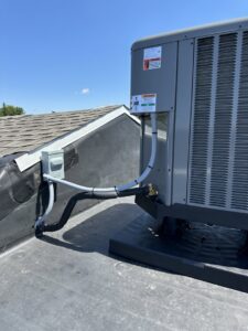 Close-up of the electrical and refrigerant line connections for a rooftop AC unit by P3 Mechanical Heating & Cooling in Bainbridge, PA.