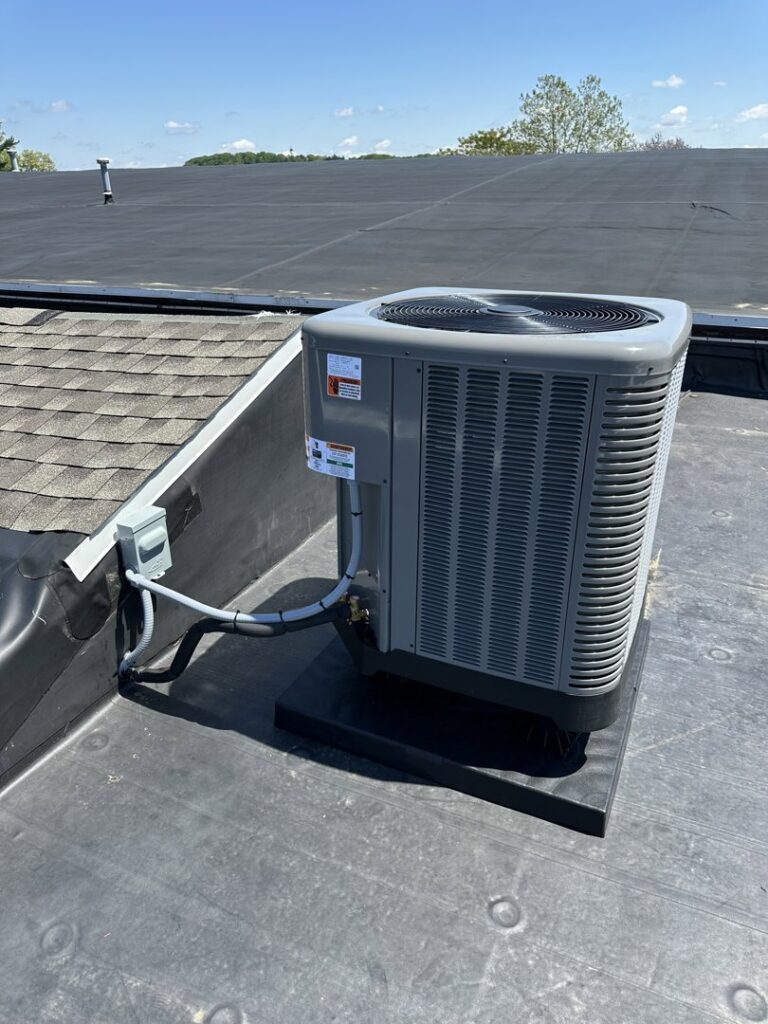 An outdoor air conditioning unit installed on a flat rooftop by P3 Mechanical Heating & Cooling in Bainbridge, PA.