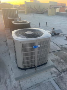 Multiple outdoor AC units installed on a rooftop by Genesis - Heating and Air Conditioning Specialist in SUNNYSIDE, NY