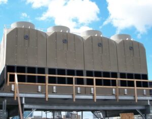 Large commercial rooftop HVAC cooling towers installed against a blue sky, showcasing work by Stillwell-Hansen Inc. in Edison, NJ.
