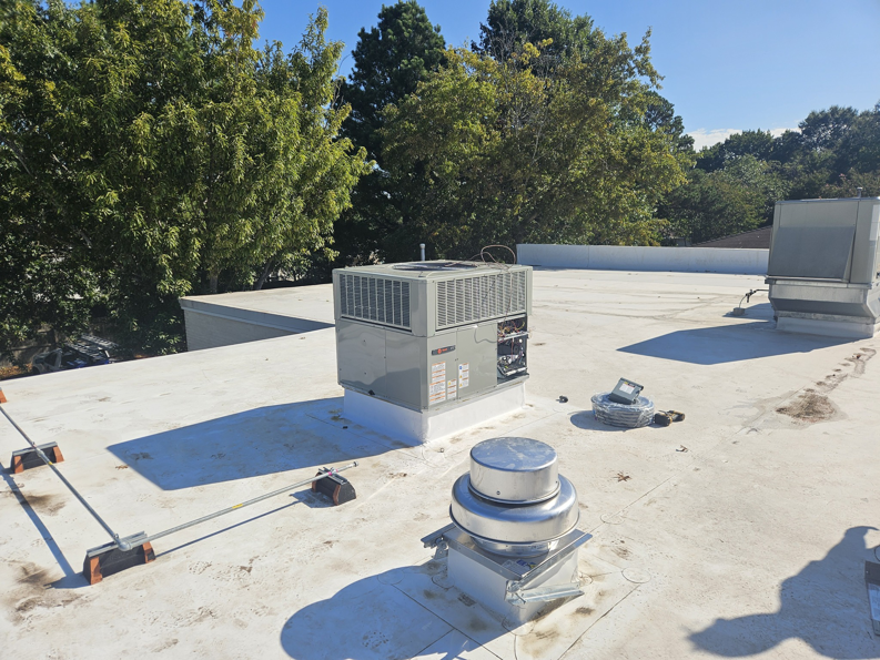 A commercial rooftop HVAC system on a building serviced by Acclimated Air LLC in Virginia Beach, VA.