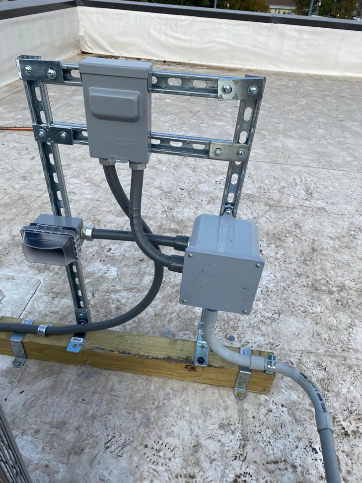 Close-up of rooftop electrical conduit and junction boxes installed by Redmond Electric LLC in Horn Lake, MS.
