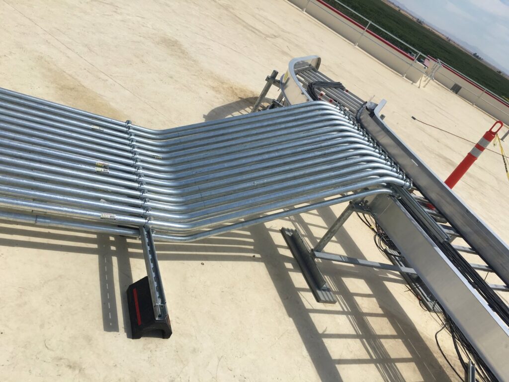 Rooftop electrical conduit installation connecting to a cable tray by New Revelation Technologies LLC in Nampa, ID.