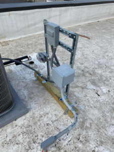 Rooftop electrical installation with conduit and boxes next to an HVAC unit by Redmond Electric LLC in Horn Lake, MS.