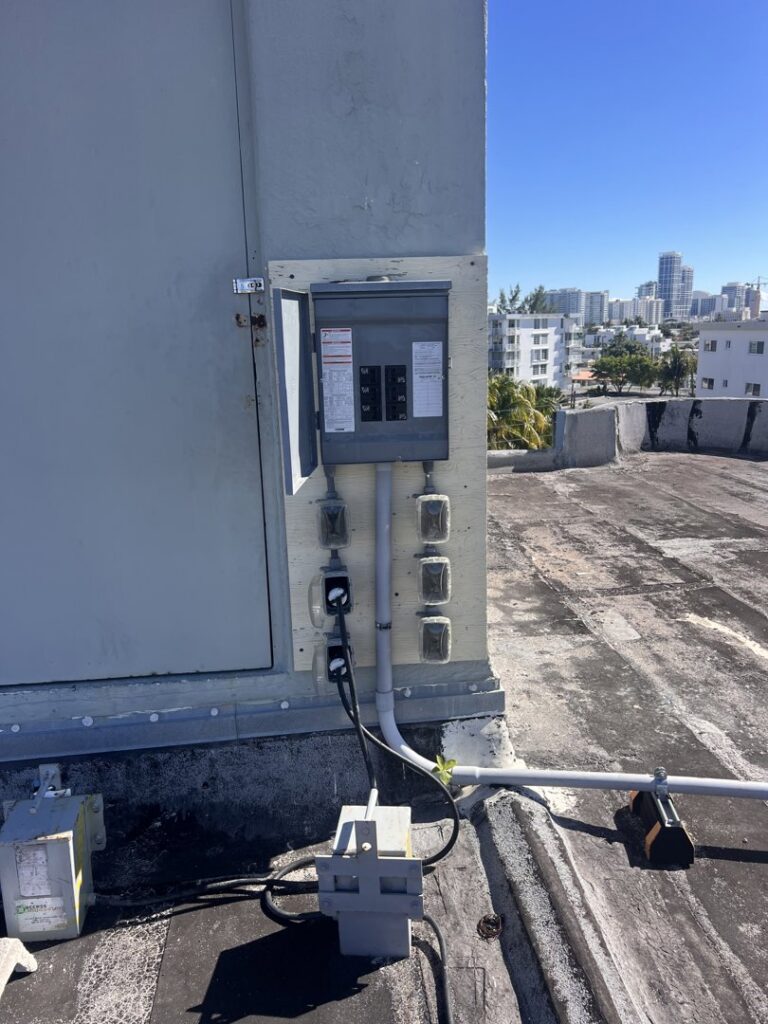 An outdoor electrical panel and conduit system installed on a rooftop by Krakkom Electric in Sunrise, FL.