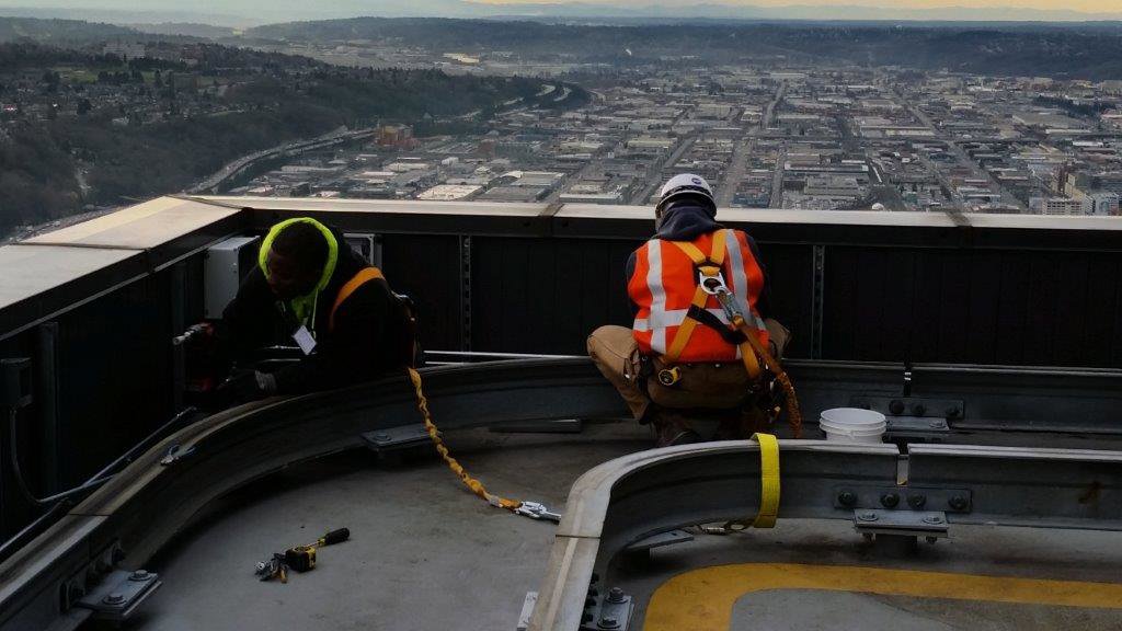 Electricians from Titan Electric performing rooftop equipment installation and maintenance in Bellevue, WA.