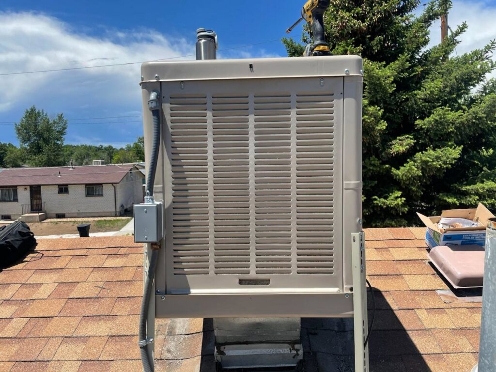 An evaporative cooler being installed or serviced on a rooftop by National Heating & Cooling Company in Lakewood, CO.