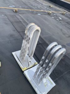Large rooftop HVAC coils, likely part of a commercial system, serviced by Service Champions Heating & Cooling in Aurora, IL.