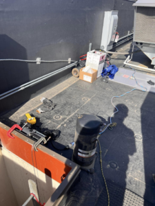 A rooftop HVAC compressor replacement in progress by Mead Heating and Cooling in Kansas City, MO.