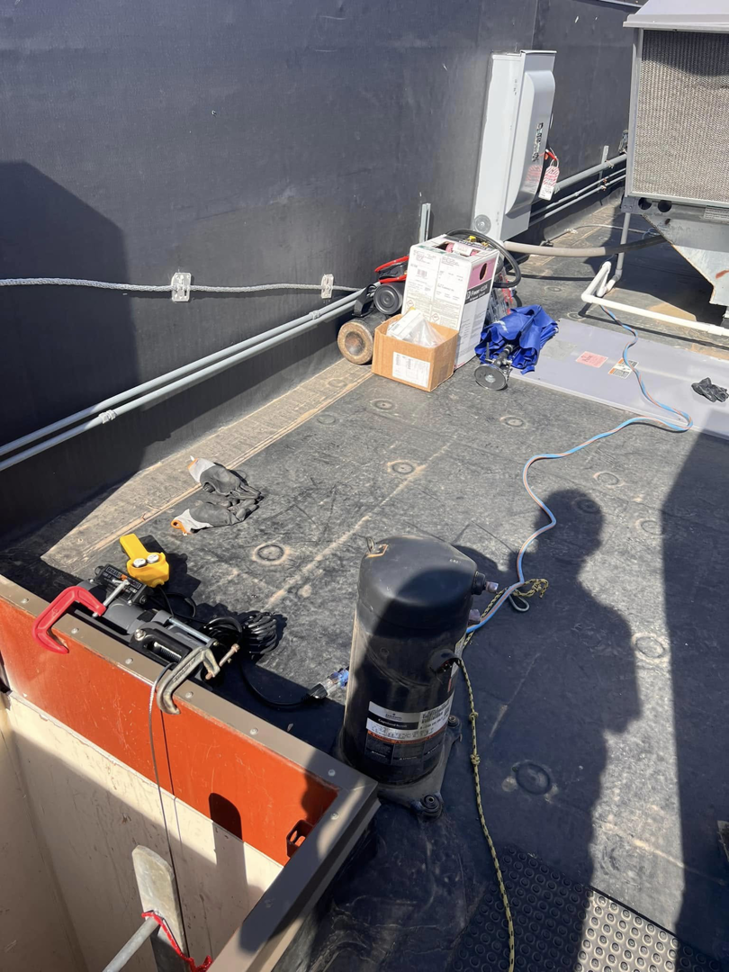A rooftop HVAC compressor replacement in progress by Mead Heating and Cooling in Kansas City, MO.