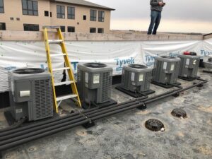 Rooftop installation of multiple HVAC condenser units by Central Heating & Air in Sioux Falls, SD