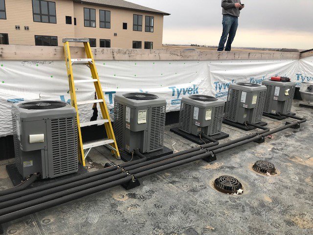 Rooftop installation of multiple HVAC condenser units by Central Heating & Air in Sioux Falls, SD
