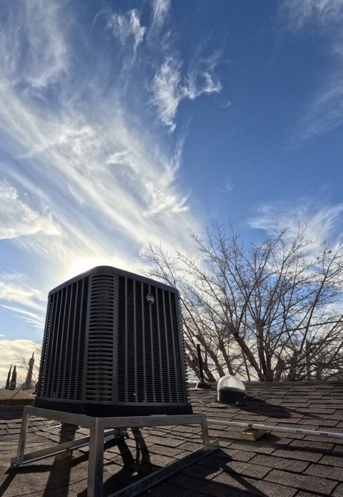 A rooftop HVAC condenser unit under a dramatic sky, installed by Ignitify Commercial Grade HVAC in El Paso, TX.