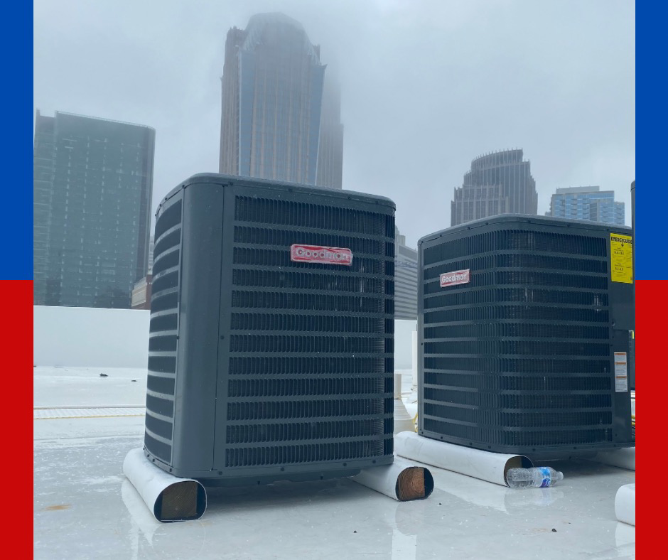 Two rooftop HVAC condenser units with a city skyline in the background, installed by Alianza Mecanica HVAC in Charlotte, NC.
