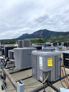 Multiple commercial rooftop HVAC condenser units installed by Husky Heating and Cooling in Westminster, CO.