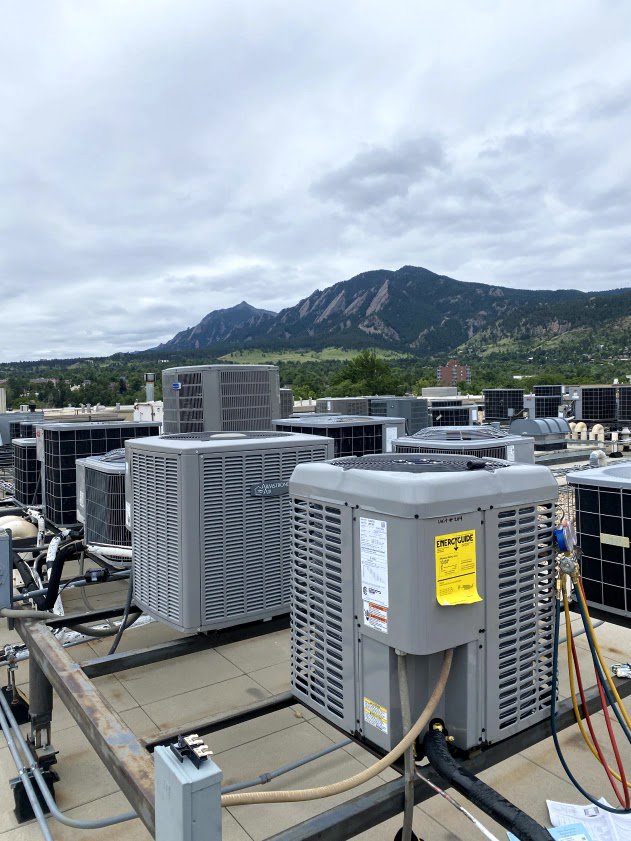 Multiple commercial rooftop HVAC condenser units installed by Husky Heating and Cooling in Westminster, CO.