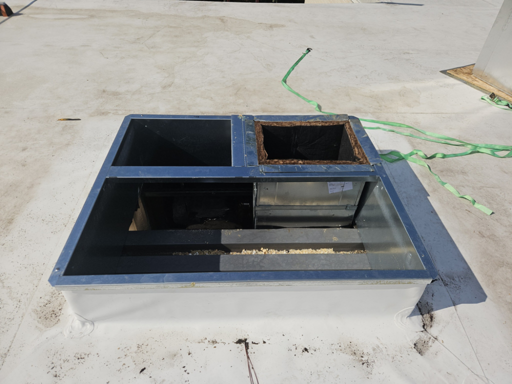 Rooftop HVAC curb with duct connections ready for unit placement by Acclimated Air LLC in Virginia Beach, VA.