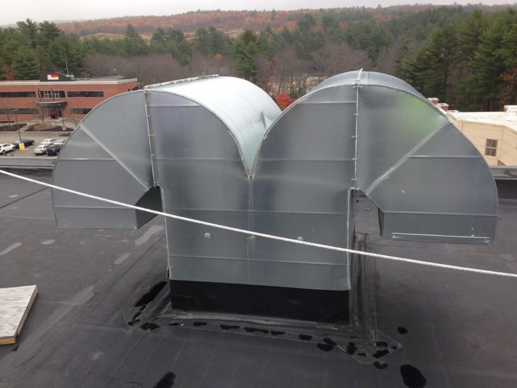 Rooftop HVAC ductwork installation with curved sections by Accurate Air in Manchester, NH