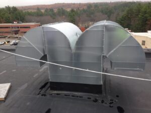 Rooftop HVAC ductwork installation with curved sections by Accurate Air in Manchester, NH