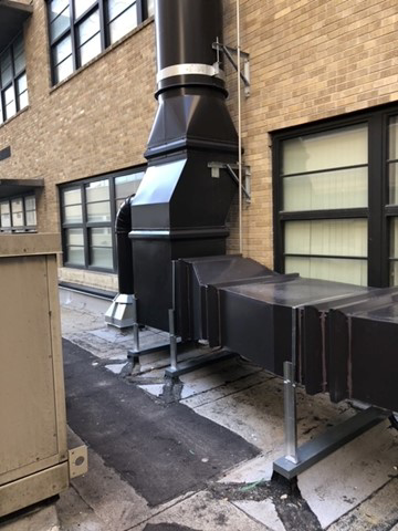 A comprehensive view of a rooftop HVAC ductwork system with horizontal and vertical sections by Kuhlmann Supply Company in Earth City, MO