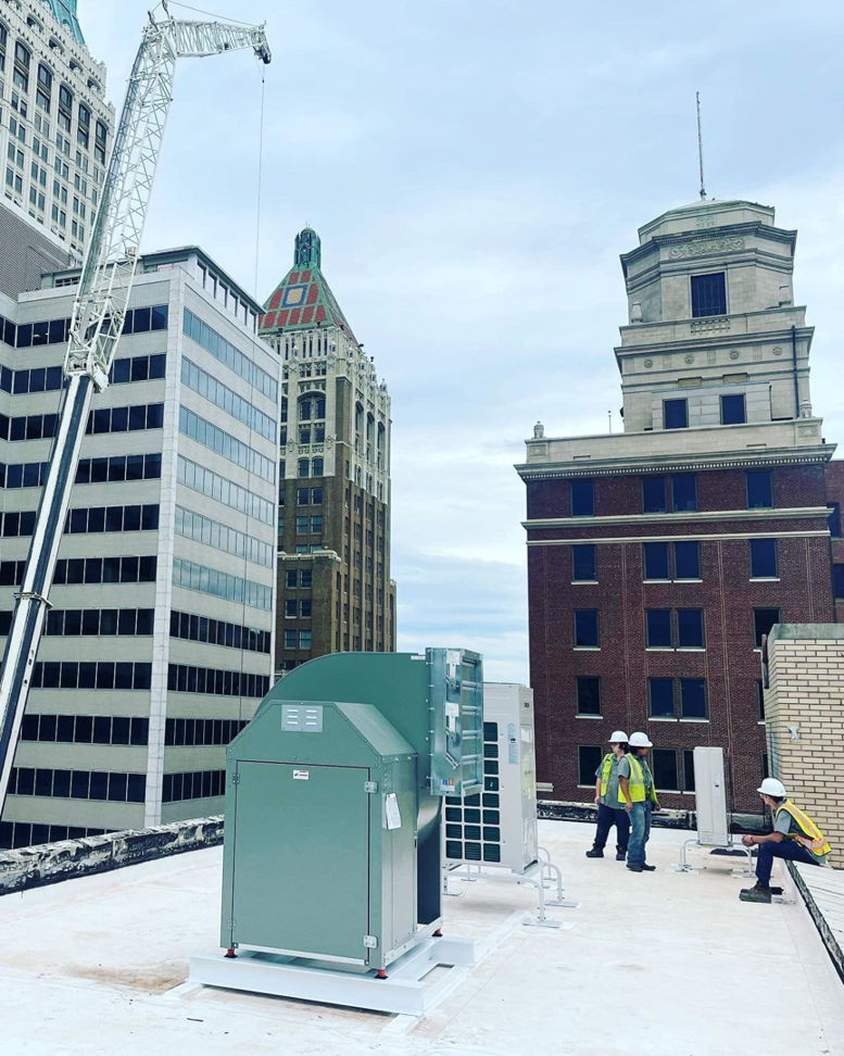 Workers installing large rooftop HVAC units for Elemental Air in Sanford, FL.
