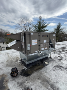 A large Luxaire rooftop HVAC unit on a commercial building, ready for maintenance by Prism Heating & Air Conditioning in Toms River, NJ.