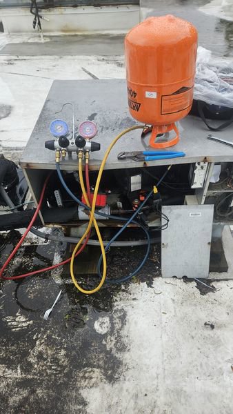 A rooftop HVAC unit undergoing a refrigerant check by Will Power Refrigeration Co in Yonkers, NY.