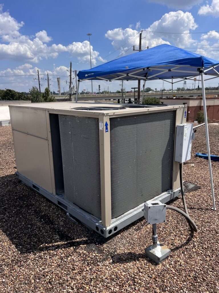 A rooftop HVAC unit being serviced under a blue canopy by Jupitair in Frisco, TX, on a sunny day.