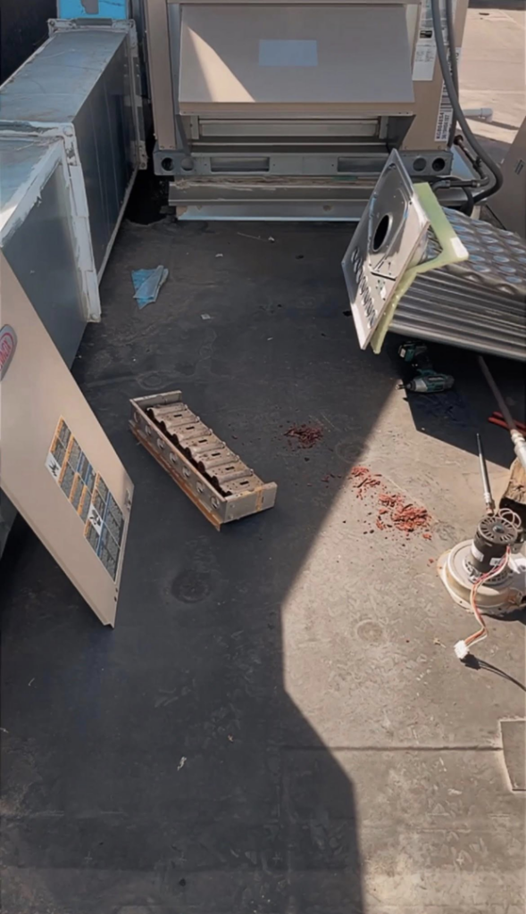 Disassembled components of a rooftop HVAC system during maintenance by Schomp's Mechanical Services in Brookings, SD.