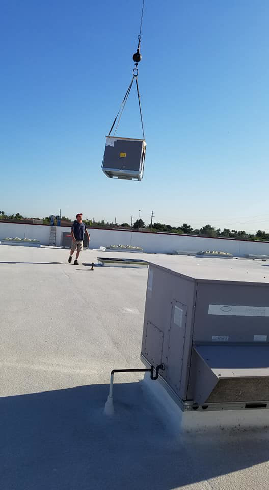 A new rooftop HVAC unit being installed by crane by GPS Mechanical LLC in Phoenix, AZ