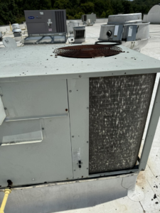 A rooftop commercial HVAC unit with dirty coils, indicating a need for maintenance from 511Comfort, LLC in Nashville, TN.