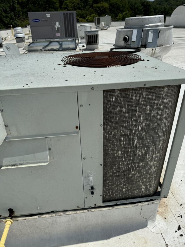 A rooftop commercial HVAC unit with dirty coils, indicating a need for maintenance from 511Comfort, LLC in Nashville, TN.