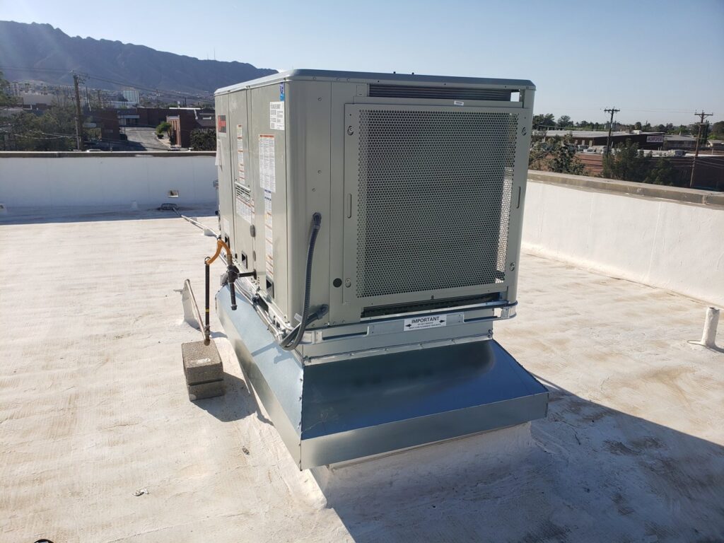 A rooftop HVAC unit installed on a white flat roof by Dynamic Heating, Cooling, Refrigeration & Roofing in El Paso, TX.
