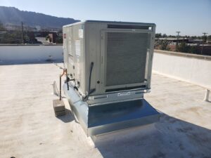 A rooftop HVAC unit installed on a white flat roof by Dynamic Heating, Cooling, Refrigeration & Roofing in El Paso, TX.