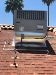 A rooftop HVAC unit installed on a tiled roof by Advanced Comfort A/C & Heating in Phoenix, AZ.