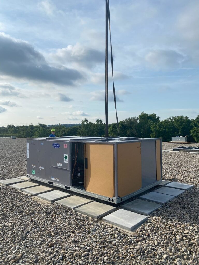 A rooftop HVAC unit being installed with a crane by Cafco Services in Cincinnati, OH.