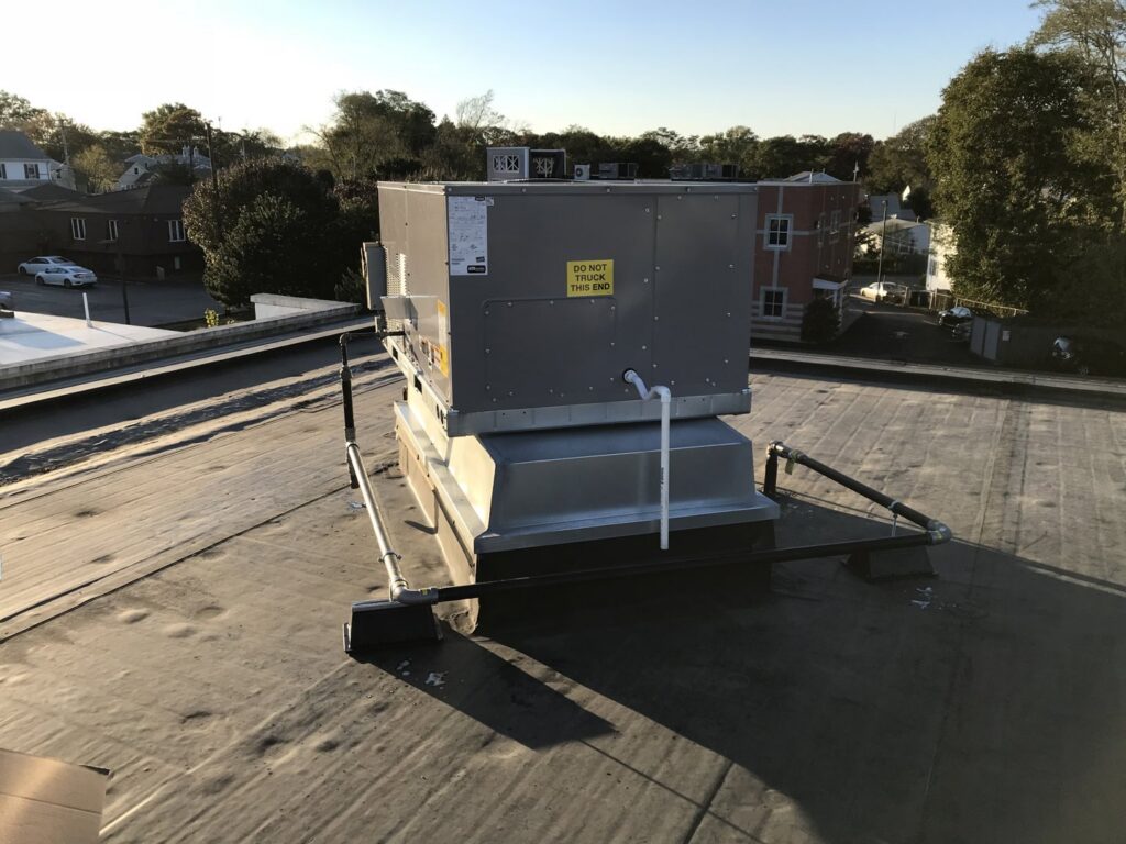 A commercial rooftop HVAC unit installed on a building by Evergreen Services in Warwick, RI.