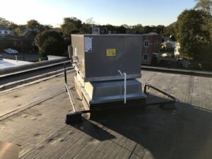 A commercial rooftop HVAC unit installed on a building by Evergreen Services in Warwick, RI.