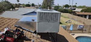 A newly installed rooftop HVAC unit on a residential home, serviced by HoxAir Heating & Cooling in Phoenix, AZ